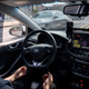 A safety driver sits behind the wheel of a self-driving taxi in South Korea.
